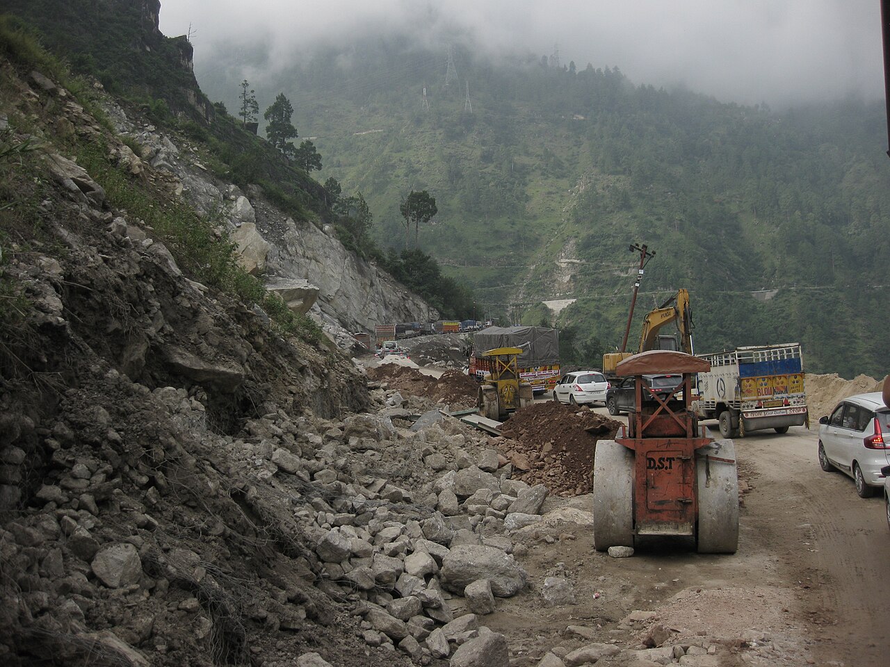 Rock debris, road works and queued vehicles at Nigulsari in Kinnaur after a landslide in September 2025